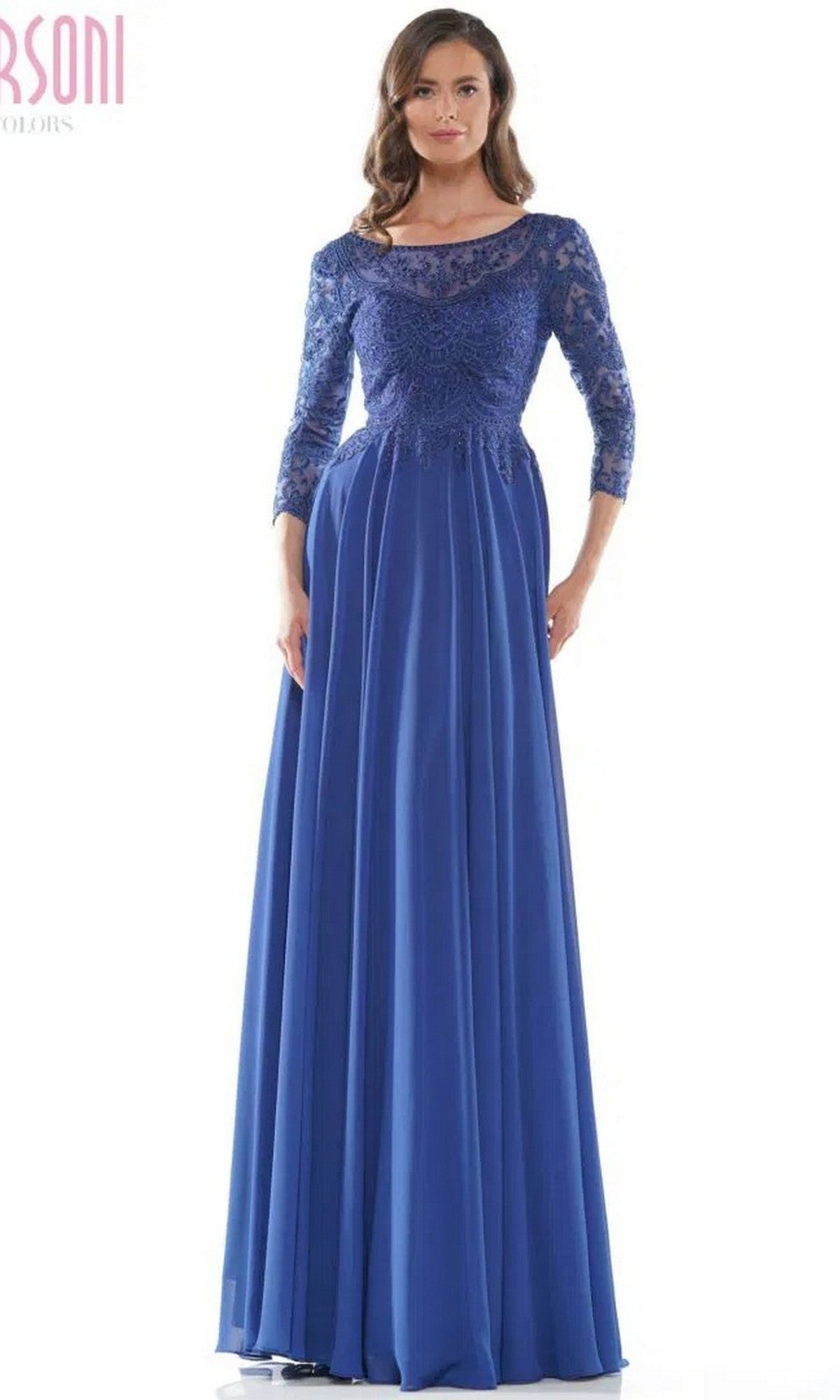 A woman in the Marsoni M238SL long formal dress, featuring royal blue lace sleeves, a beaded fitted bodice, and a flowing chiffon A-line skirt, stands against a white background.